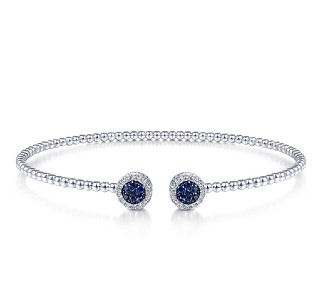 Sapphire accented white gold beaded cuff with diamond halos around the dark blue gems