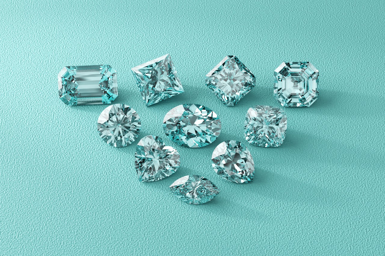 A group of sparkling diamonds in shapes including round, emerald, and heart, on a textured turquoise background.