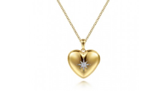 a yellow gold necklace featuring a heart shaped pendant with diamond accents