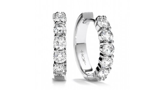 a pair of white gold huggie earrings each set with five round cut diamonds