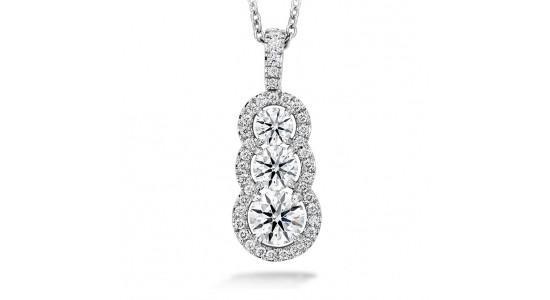a white gold pendant necklace featuring a tiered diamond pendant with accent diamonds