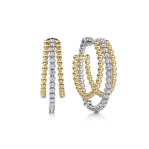 Elegant hoop earrings with alternating rows of gold beads and sparkling diamonds.